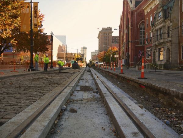 Recently laid Cincinnati streetcar trackage in Elm St. on Nov. 8th. Original granite pavers are being reinstalled to restore historic appearance. Photo: Travis Estell (Flickr).