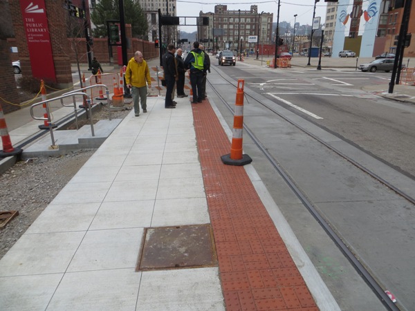 Members of APTA Streetcar Committee inspect streetcar station-stop under construction on Walnut St. in Cincinnati CBD. Photo: L. Henry.