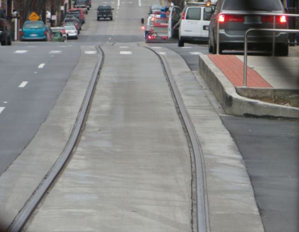 Completed section of streetcar track veers slightly toward station platform. Photo: L. Henry.