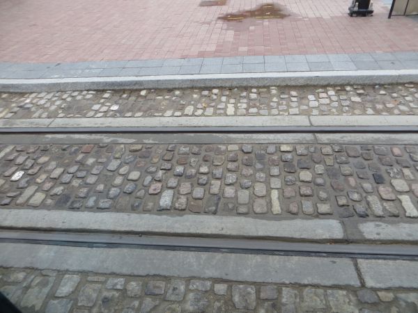 Section of streetcar track embedded in cobblestone paving. Photo: L. Henry.