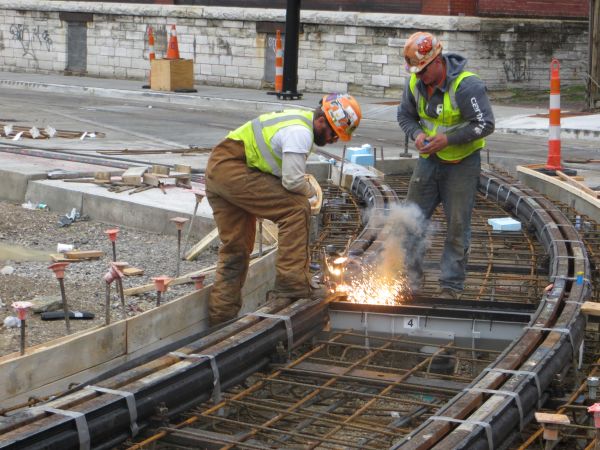 Workers performing thermal weld on track leading into carbarn storage yard. Photo: L. Henry.